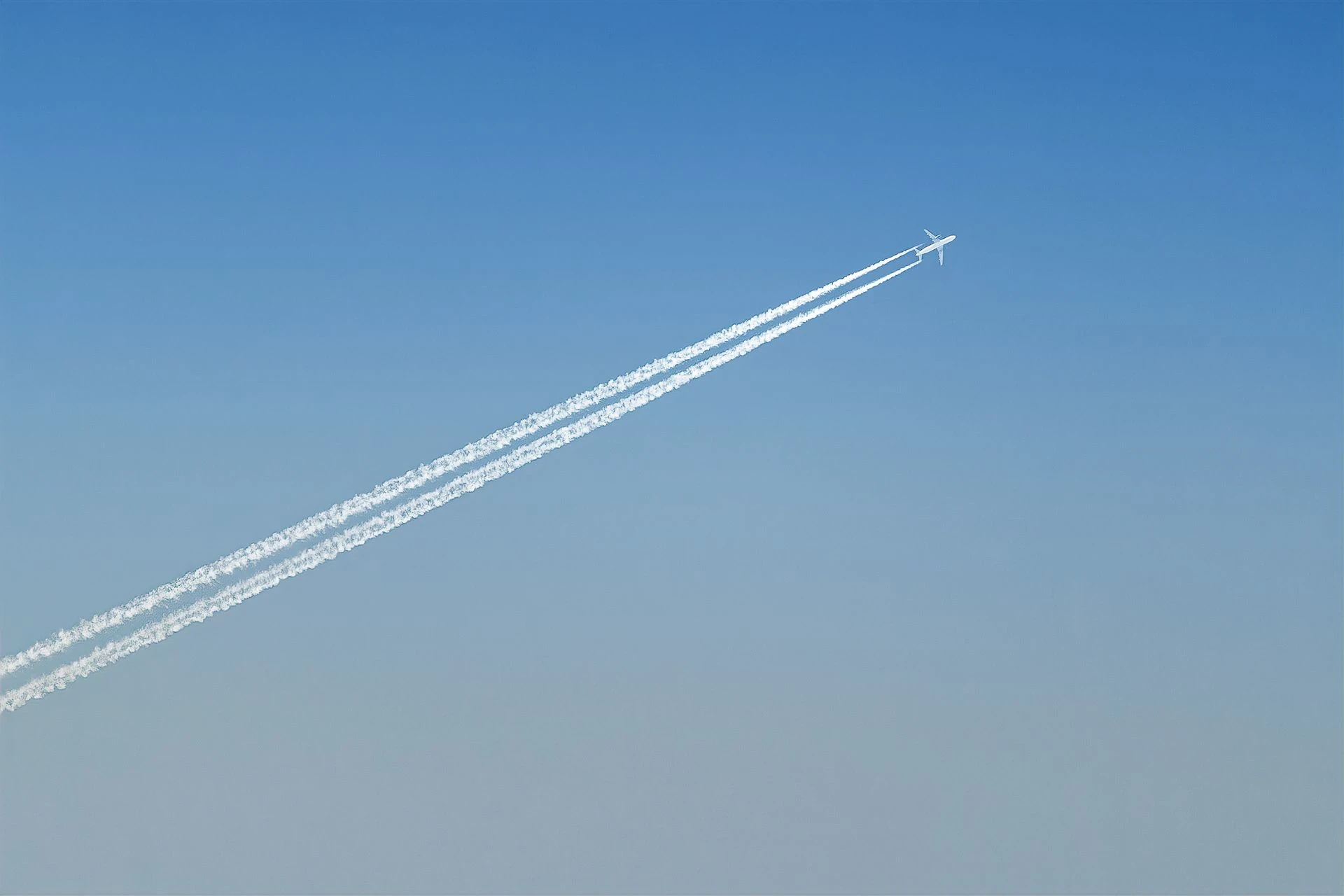 Airplane leaving a trail in a blue sky
