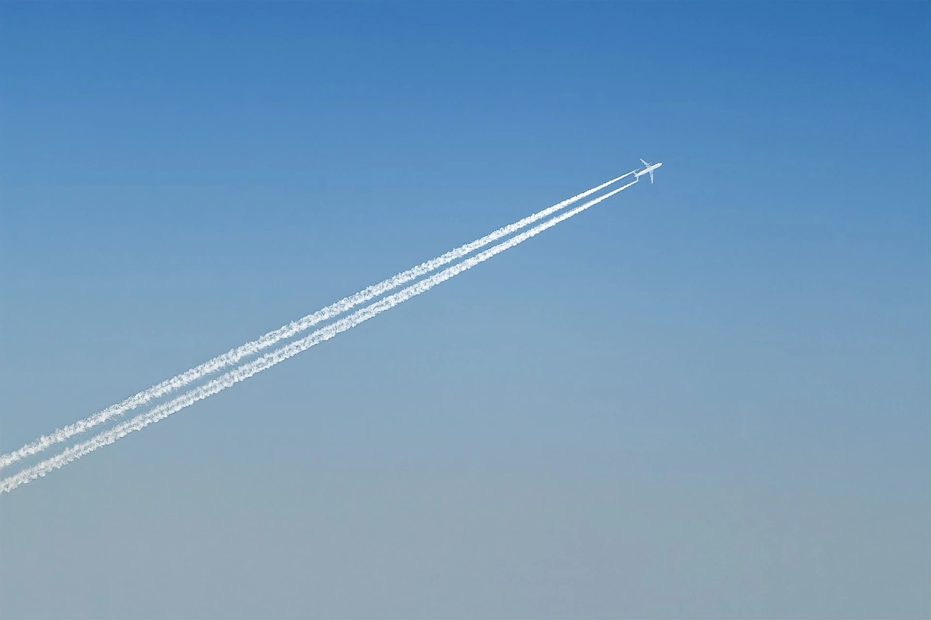 Airplane leaving a trail in a blue sky