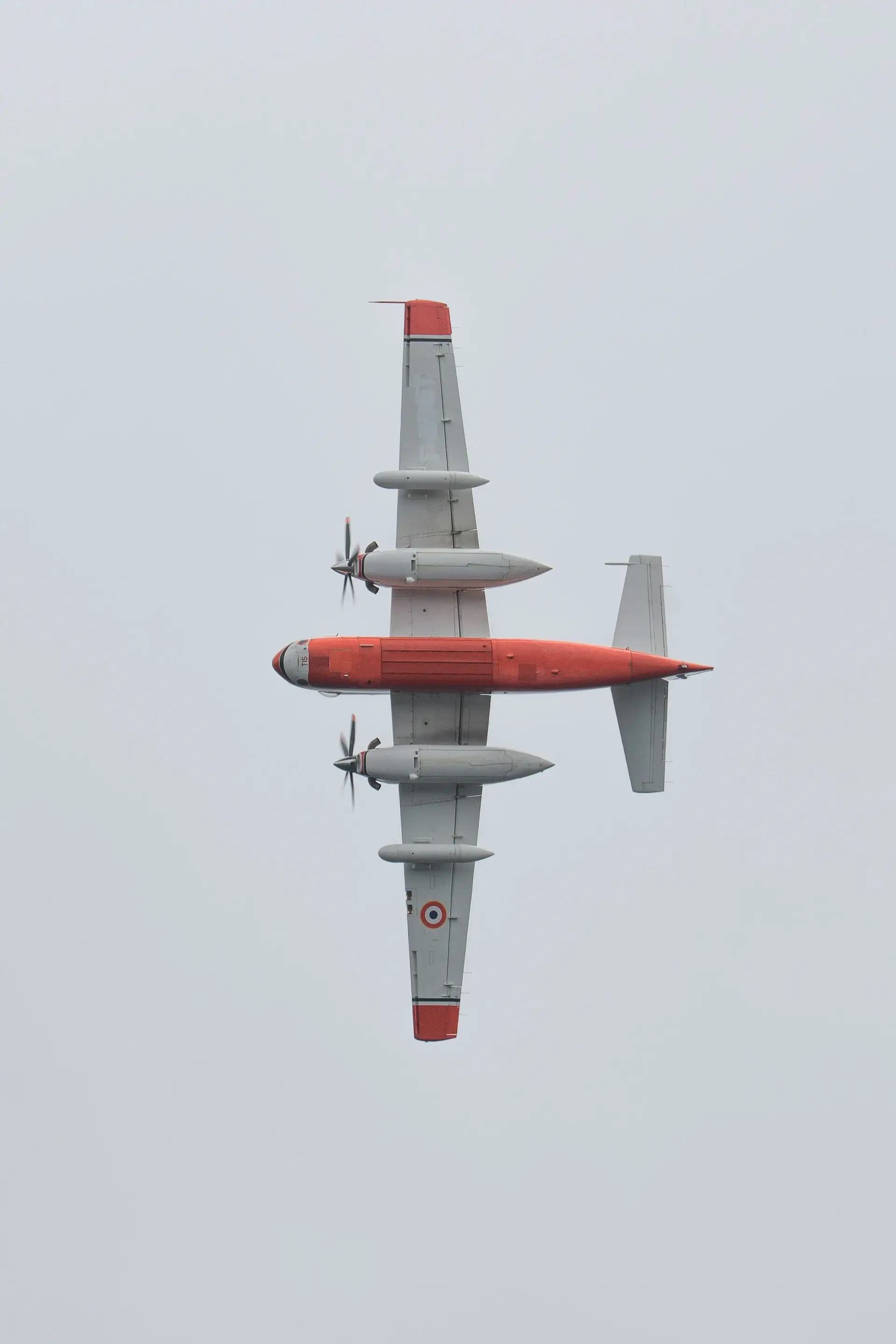 Turboprop aircraft in flight, viewed from below
